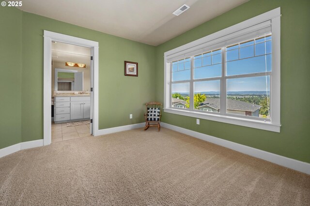 empty room featuring carpet flooring and baseboards