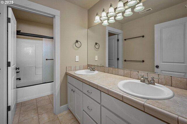 bathroom with double vanity, tile patterned flooring, and shower / bath combination with glass door