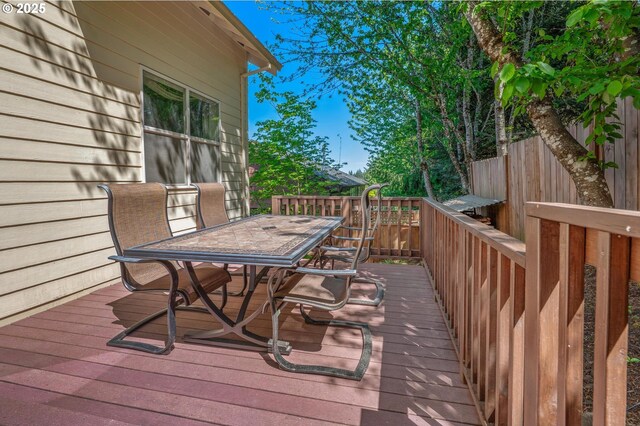 wooden terrace featuring outdoor dining space