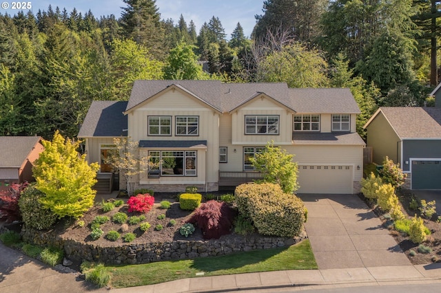 view of front of house with board and batten siding, concrete driveway, and an attached garage