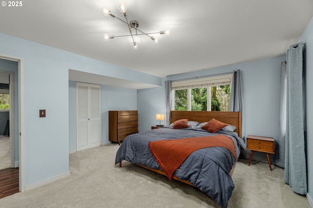 bedroom featuring an inviting chandelier, a closet, and carpet floors