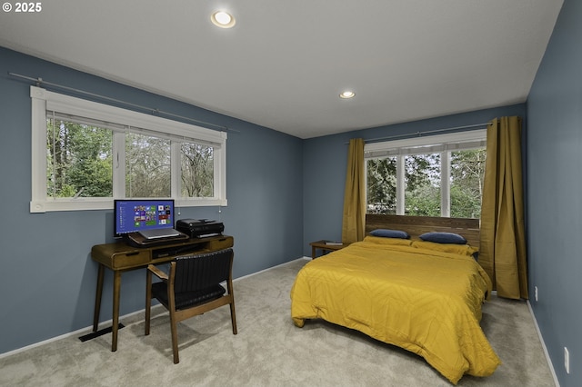 carpeted bedroom featuring multiple windows