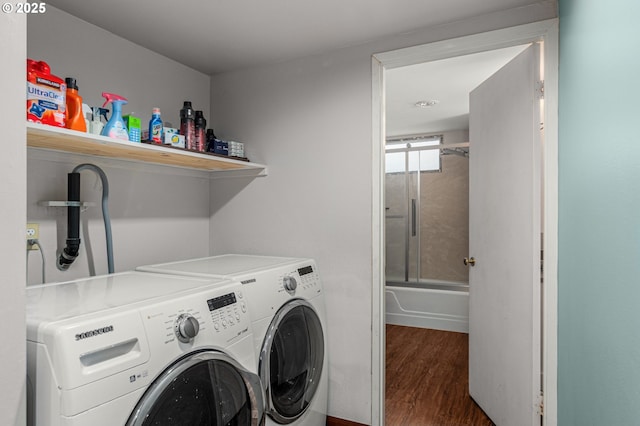 laundry area with dark wood-type flooring and washing machine and clothes dryer