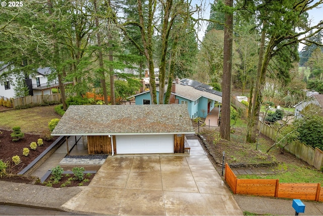 view of front of home featuring solar panels and a garage