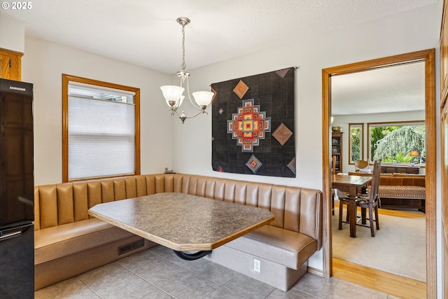 dining area with breakfast area and a notable chandelier