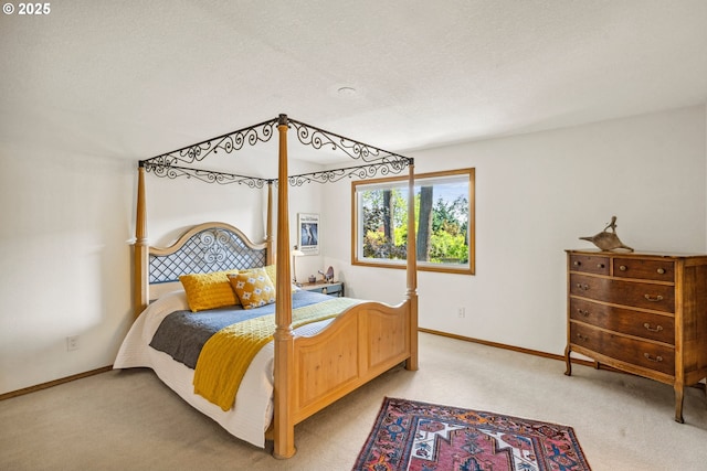 bedroom with baseboards and light carpet