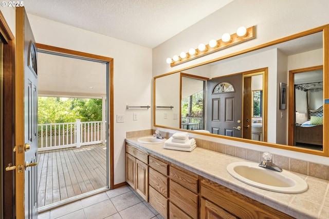 bathroom with double vanity, a sink, and a wealth of natural light