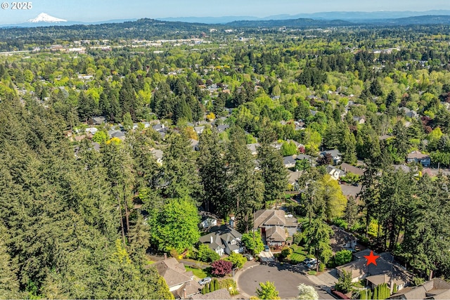 birds eye view of property with a residential view, a mountain view, and a wooded view