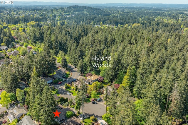 birds eye view of property with a view of trees