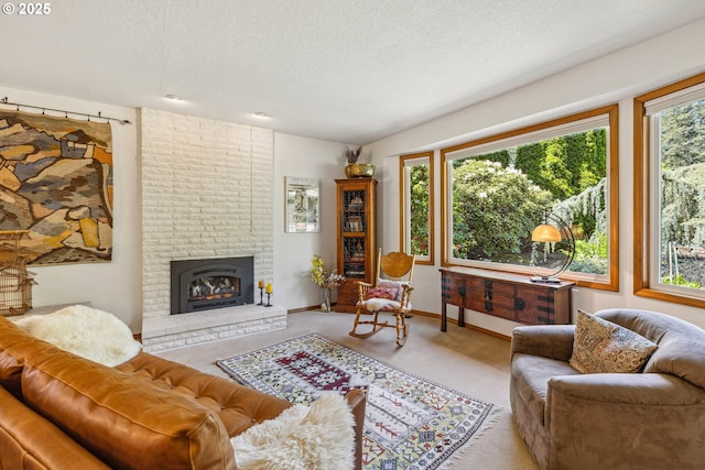 living area with carpet floors, a textured ceiling, baseboards, and a fireplace