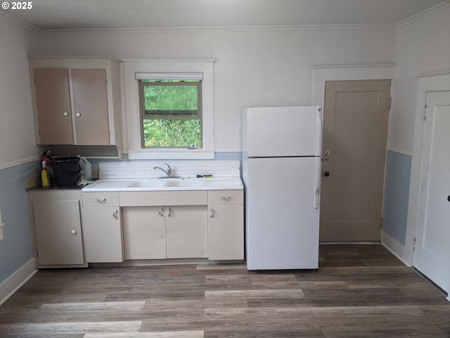 kitchen with white cabinetry, sink, white refrigerator, crown molding, and light wood-type flooring