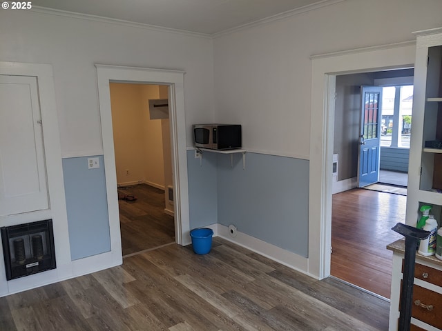 interior space with hardwood / wood-style flooring and crown molding