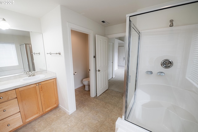 bathroom with tile patterned flooring, visible vents, toilet, vanity, and a stall shower