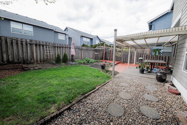 view of yard featuring a patio area, a fenced backyard, and a pergola