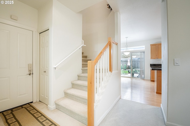 stairway with carpet floors and baseboards