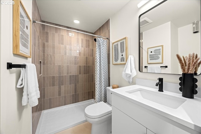 full bathroom with toilet, visible vents, a tile shower, and vanity