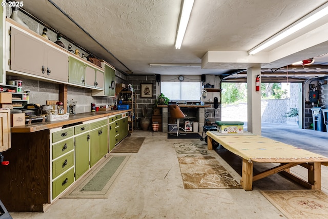 2407 Hawkins Ln, Eugene, OR 97405 - kitchen featuring green cabinets, concrete floors, a textured ceiling, and butcher block counters