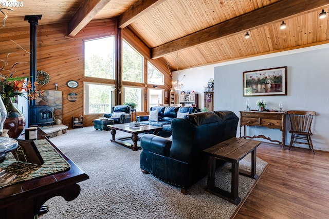 2407 Hawkins Ln, Eugene, OR 97405 - living area featuring a wood stove, a wooden ceiling with exposed beams, wood finished floors, and high vaulted ceiling