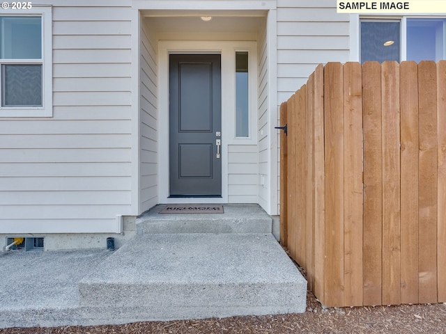 view of exterior entry with fence