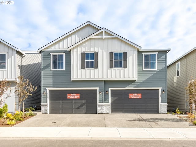 728 NW 178th Way, Ridgefield, WA 98642 - view of front of property featuring board and batten siding, an attached garage, stone siding, and concrete driveway