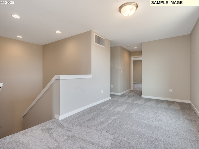 empty room with recessed lighting, visible vents, carpet floors, and baseboards