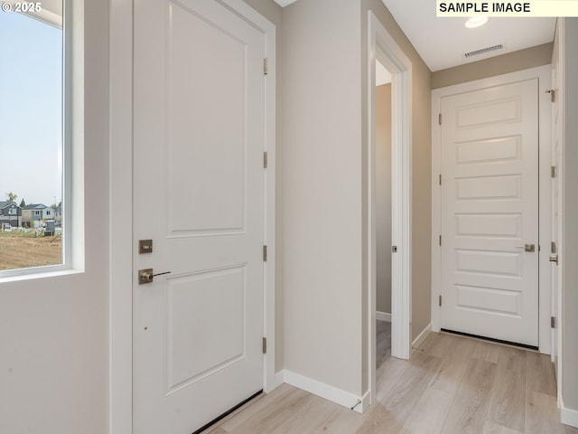 entryway featuring visible vents, baseboards, and light wood-style floors