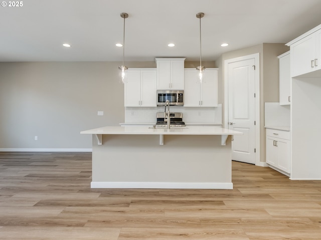 728 NW 178th Way, Ridgefield, WA 98642 - kitchen featuring stainless steel appliances, baseboards, light countertops, tasteful backsplash, and white cabinetry