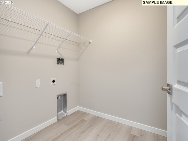 laundry area with laundry area, light wood finished floors, baseboards, and hookup for an electric dryer