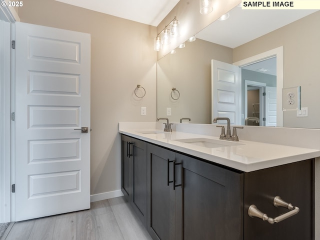 bathroom with vanity and hardwood / wood-style flooring