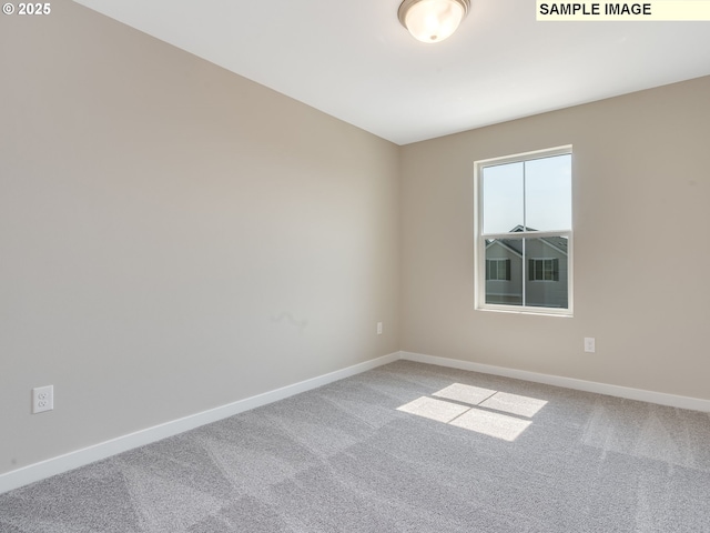 carpeted spare room with baseboards