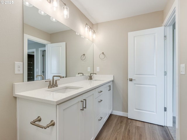 728 NW 178th Way, Ridgefield, WA 98642 - bathroom with wood finished floors, double vanity, and baseboards