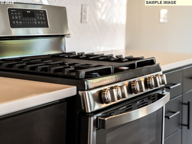 room details with tasteful backsplash and stainless steel gas range oven