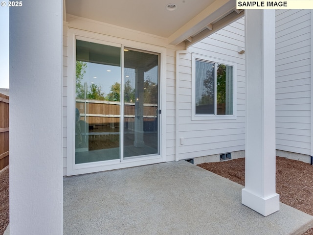 entrance to property featuring crawl space and fence