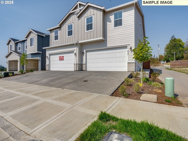 view of front of home with a garage, brick siding, board and batten siding, and concrete driveway