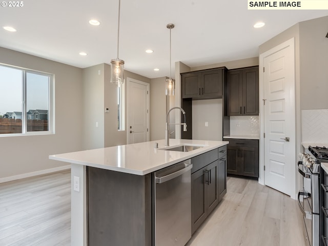 kitchen with tasteful backsplash, light wood-type flooring, light countertops, stainless steel appliances, and a sink