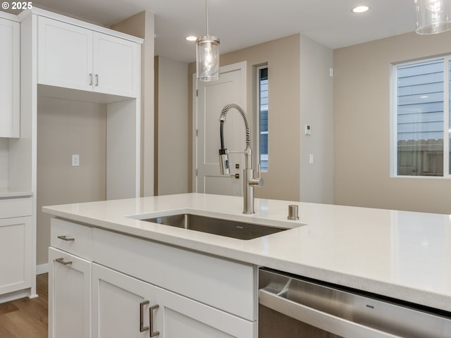728 NW 178th Way, Ridgefield, WA 98642 - kitchen with stainless steel dishwasher, a sink, recessed lighting, wood finished floors, and light countertops