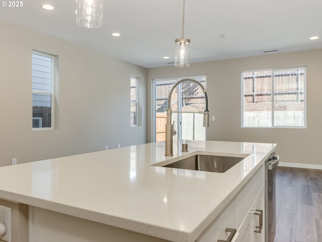 728 NW 178th Way, Ridgefield, WA 98642 - kitchen featuring a sink, recessed lighting, dark wood-style flooring, white cabinetry, and an island with sink