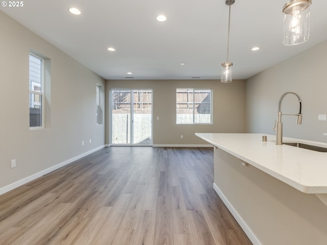 728 NW 178th Way, Ridgefield, WA 98642 - unfurnished living room featuring a sink, recessed lighting, baseboards, and wood finished floors