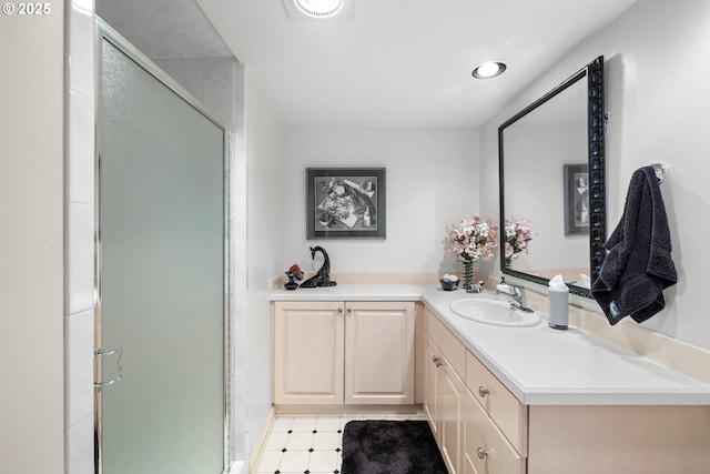 bathroom with vanity and a shower with shower door