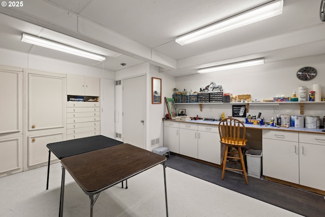 kitchen featuring white cabinetry and built in desk