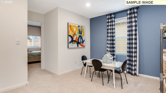 carpeted dining space featuring baseboards