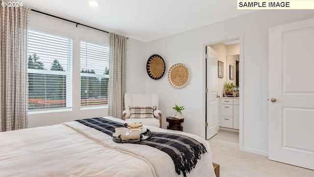 bedroom featuring light colored carpet and connected bathroom