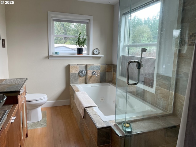 full bathroom featuring a jetted tub, baseboards, toilet, an enclosed shower, and vanity