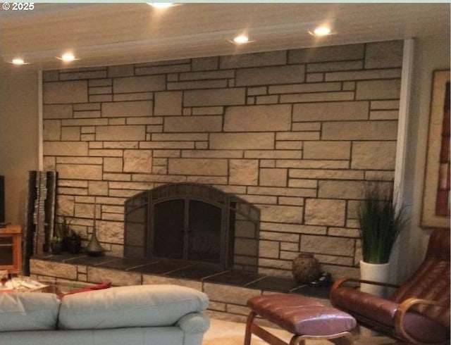 living room featuring a stone fireplace