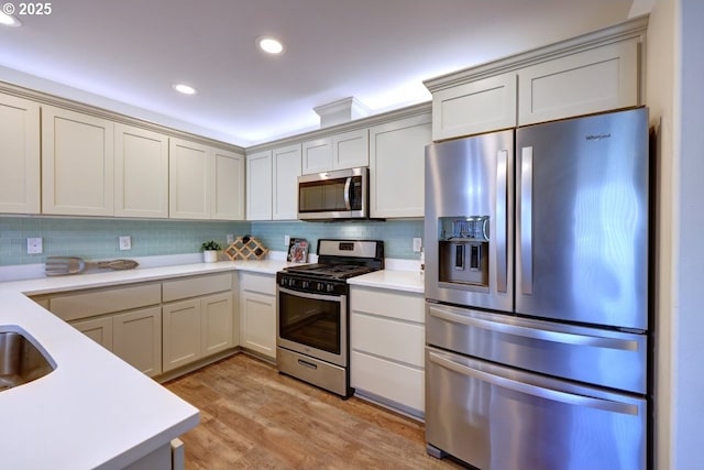 27 NW 6th Pl, Warrenton, OR 97146 - kitchen featuring backsplash, appliances with stainless steel finishes, and light countertops
