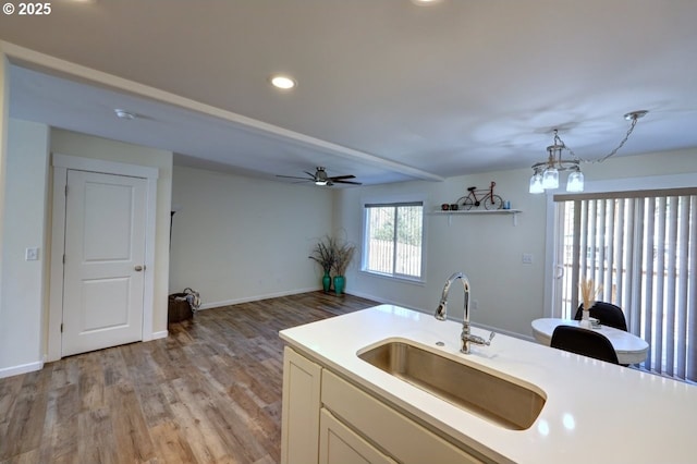 27 NW 6th Pl, Warrenton, OR 97146 - kitchen with a sink, recessed lighting, light wood-style floors, ceiling fan with notable chandelier, and light countertops