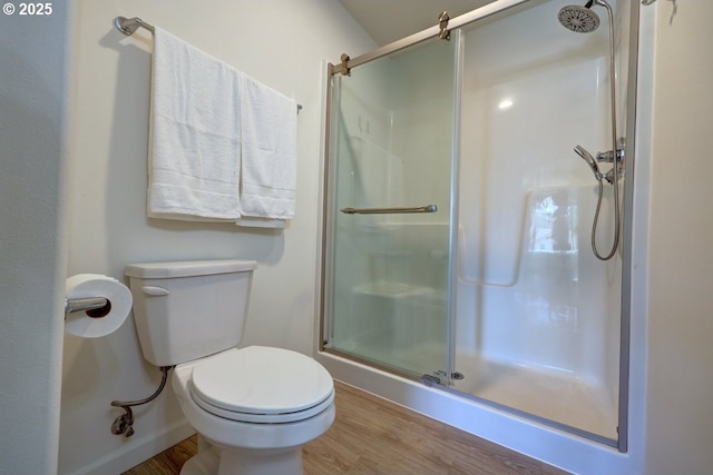 27 NW 6th Pl, Warrenton, OR 97146 - bathroom featuring toilet, baseboards, wood finished floors, and a stall shower