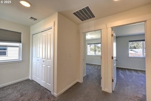 27 NW 6th Pl, Warrenton, OR 97146 - corridor with baseboards, visible vents, and dark carpet