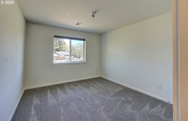 27 NW 6th Pl, Warrenton, OR 97146 - empty room with baseboards, dark colored carpet, and visible vents