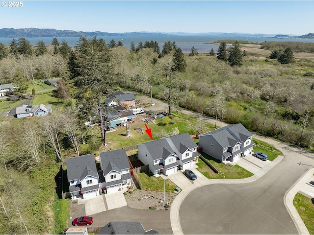 27 NW 6th Pl, Warrenton, OR 97146 - birds eye view of property with a residential view, a wooded view, and a water and mountain view